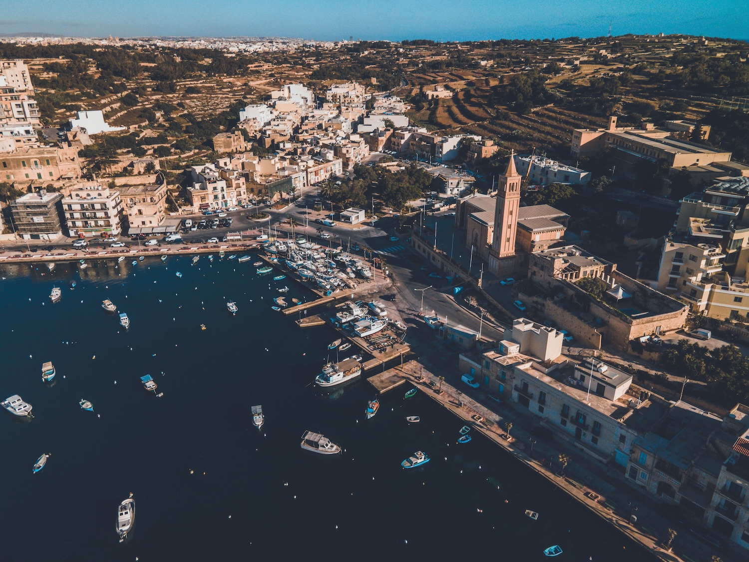 A view of Marsascala harbour by drone to represent seafront property for sale in Marsascala
